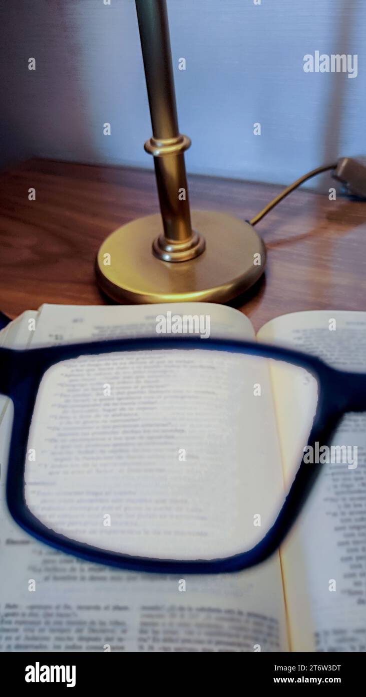 reading glasses and eyewear that magnify the text of a book for better reading Stock Photo