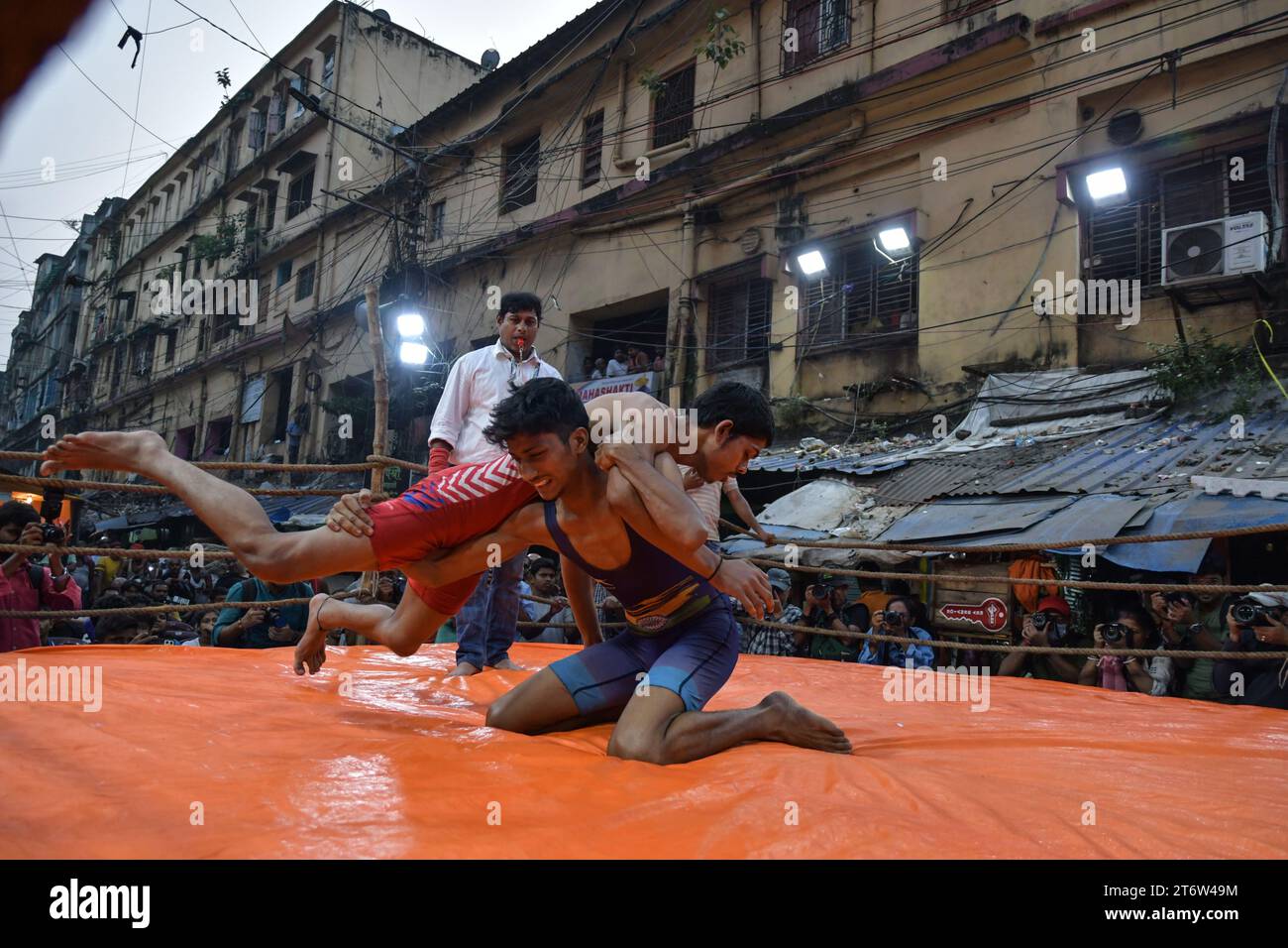 Wrestlers participate in an openair street wrestling competition named