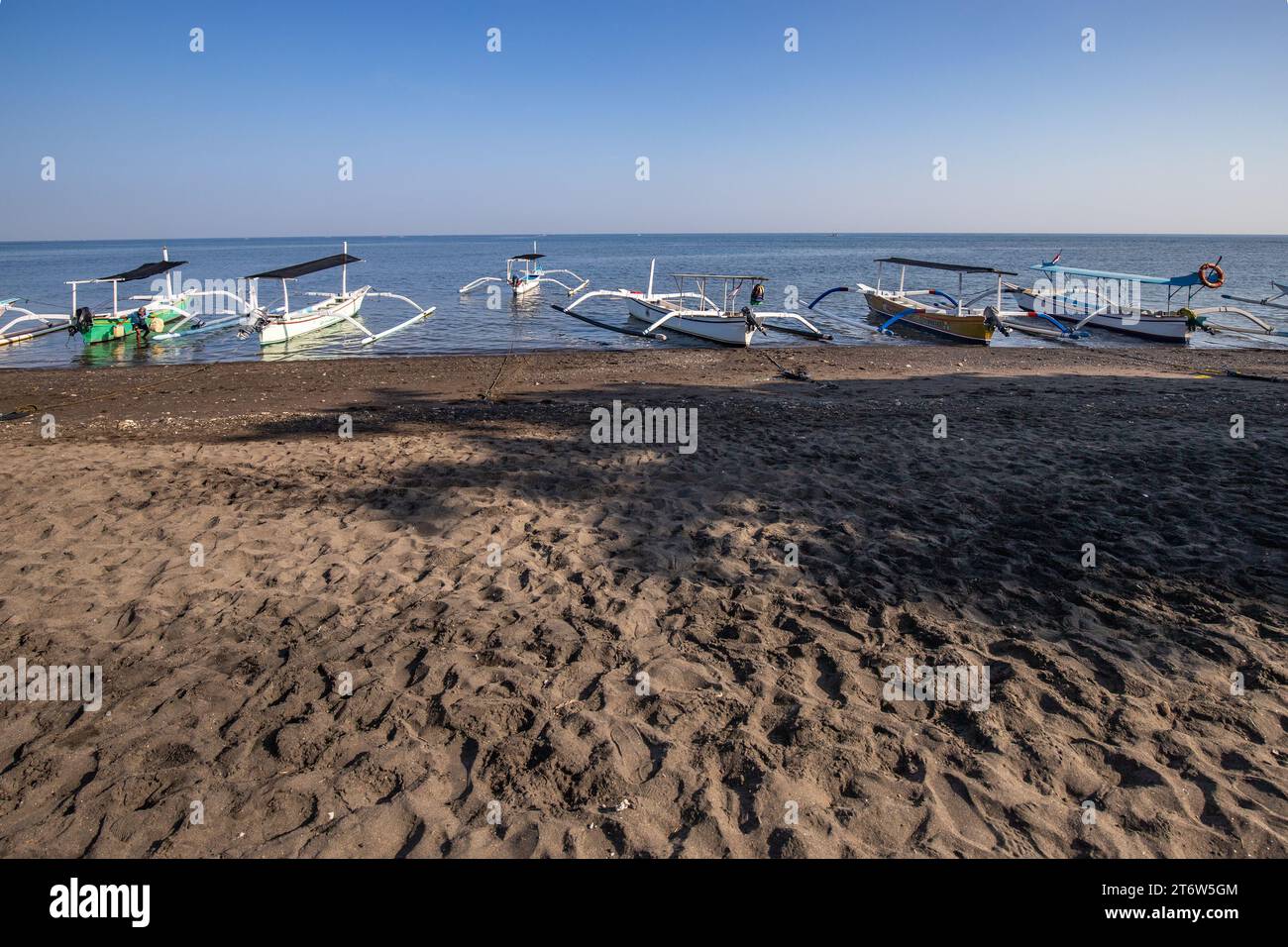 Jukung on the beach by the sea. Traditional fishing boat in the morning light. In Lovina, Bali Stock Photo