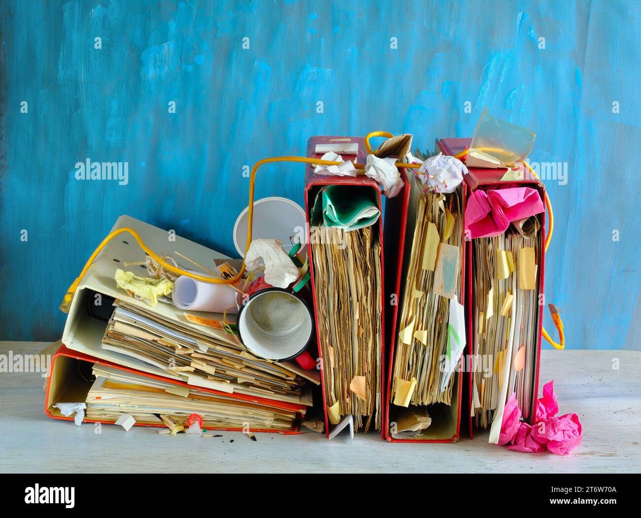 Row of messy file folders,red tape,messy office work place,bureaucracy,aministration,business concept, free copy space Stock Photo