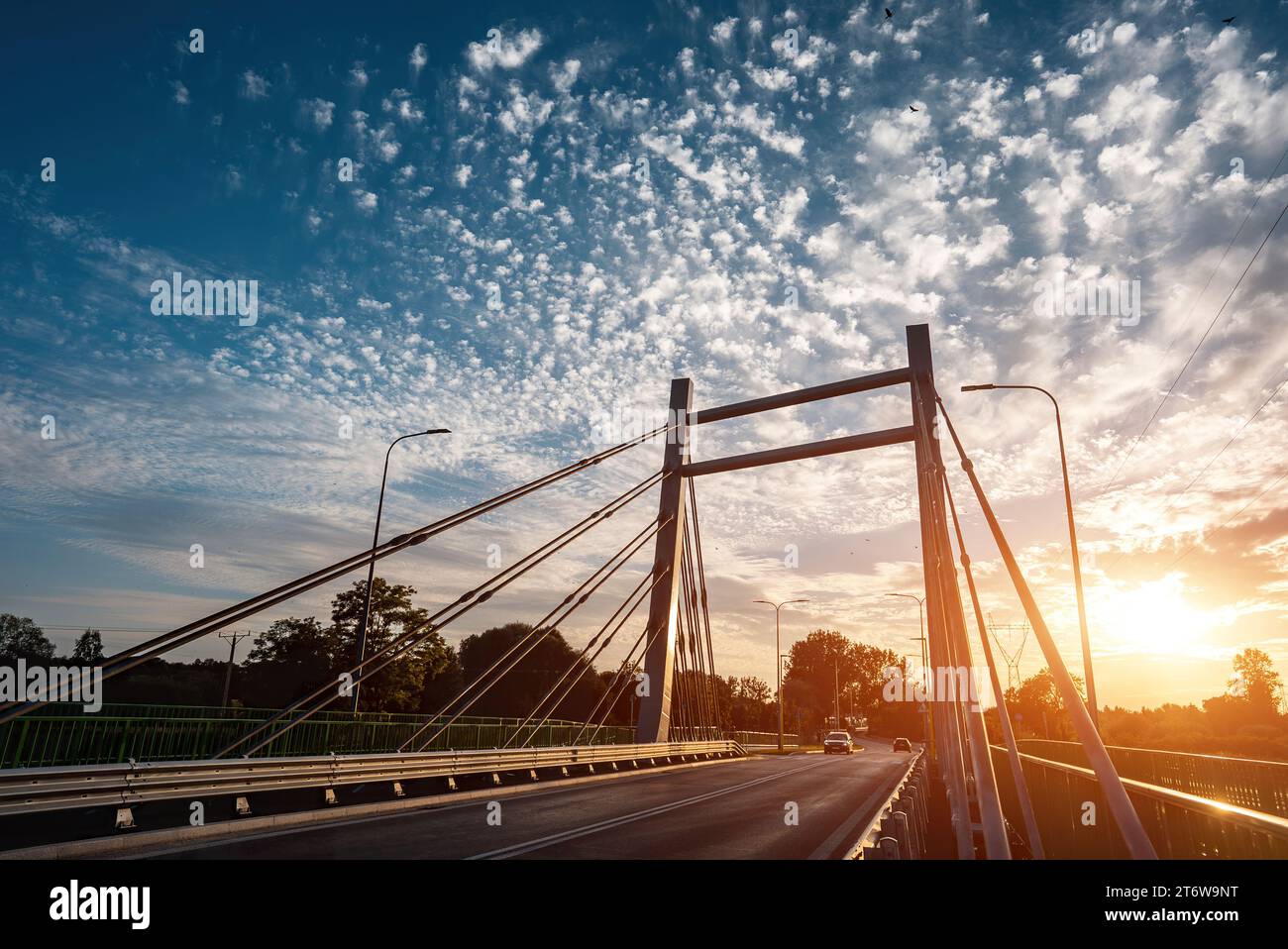 modern metal cable bridge over Bystrzyca river, sunset, Zeglarska street, Lublin Stock Photo