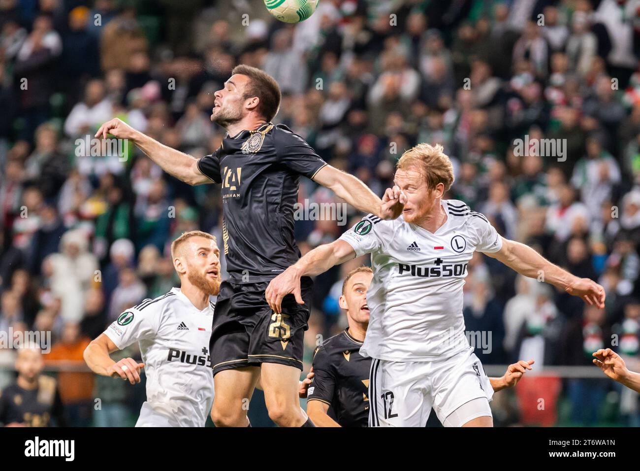 Rafal Augustyniak (L) of Legia, Mario Cuze (C) of Zrinjski, Radovan Pankov (R) of Legia are seen in action during the UEFA Europa Conference League group stage match between Legia Warszawa and HSK Zrinjski Mostar at Marshal Jozef Pilsudski Legia Warsaw Municipal Stadium.Final score; Legia Warszawa 2:0 HSK Zrinjski Mostar. (Photo by Mikolaj Barbanell / SOPA Images/Sipa USA) Stock Photo