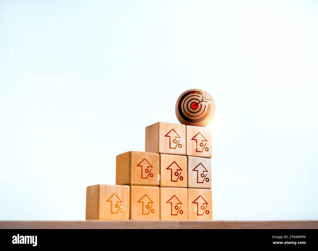 Target icon on wooden sphere on top of cube blocks bar graph chart ...