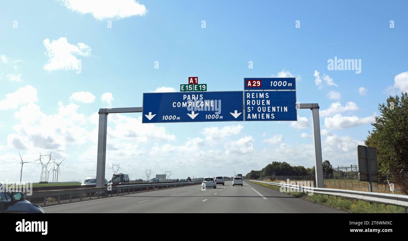 large road sign with French locations to go to the city of Paris or