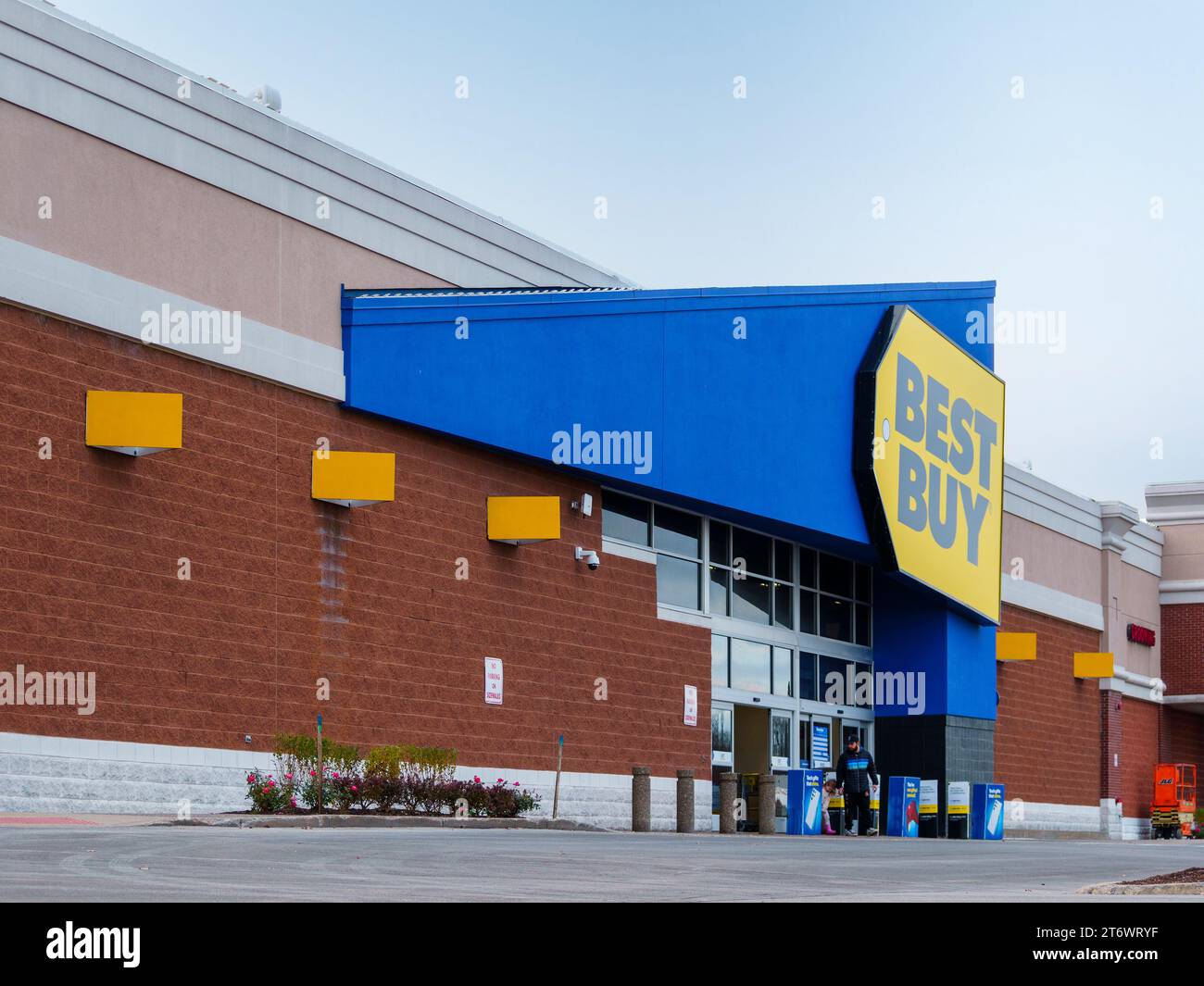 New Hartford, New York - Nov 11, 2023: Close-up Landscape View of Best Buy Store Entrance with Customer Leaving out. Stock Photo