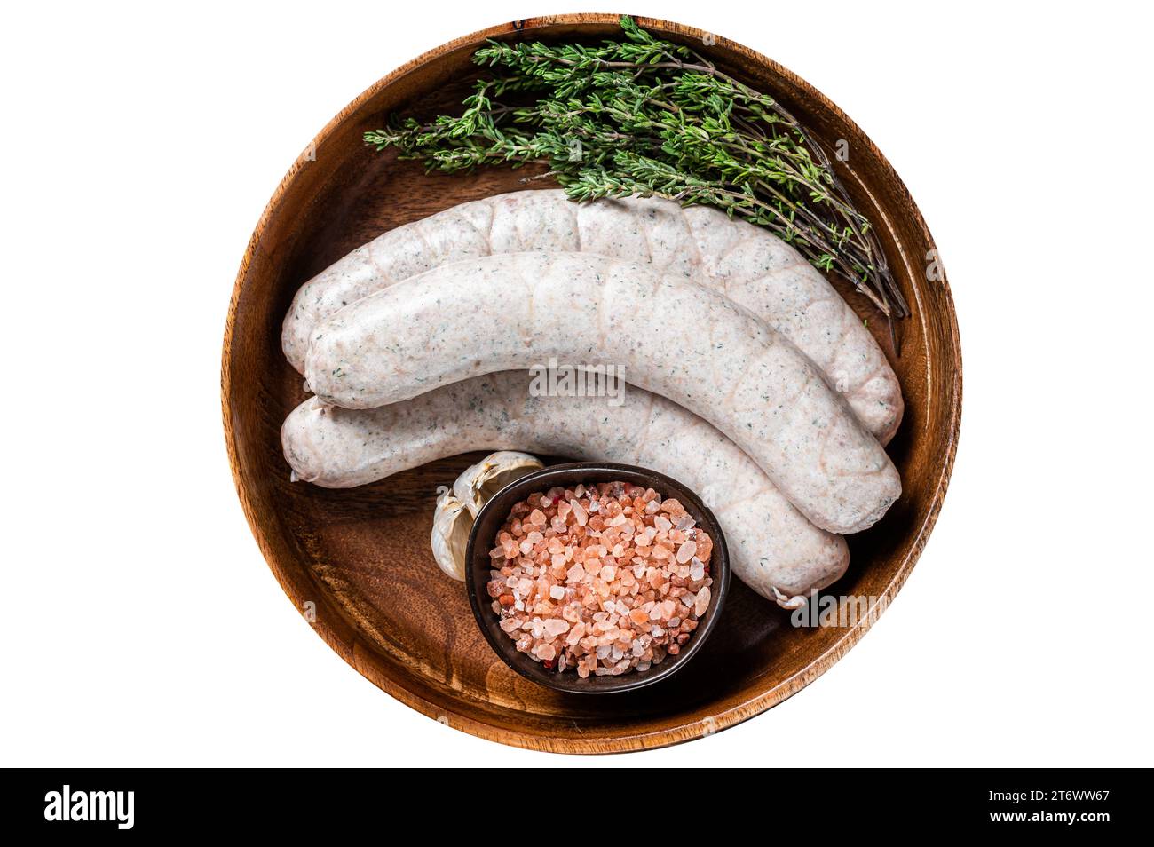 Raw Munich traditional white sausages in a wooden plate with herbs. Isolated, white background. Top view Stock Photo