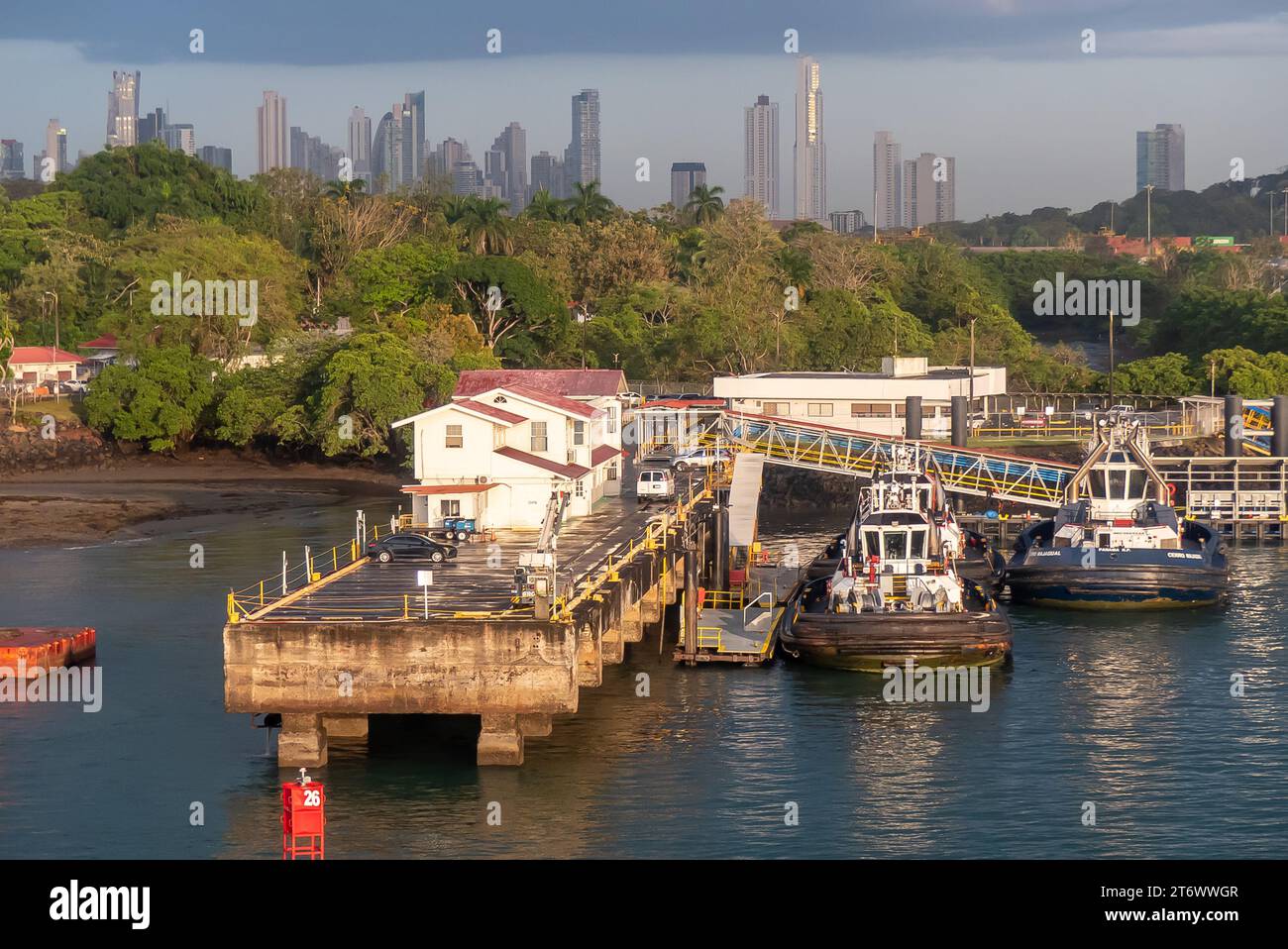 The Panama Canal: Embarcadero de Diablo, and the high-rise towers of Panama City appearing above the rainforest. Stock Photo