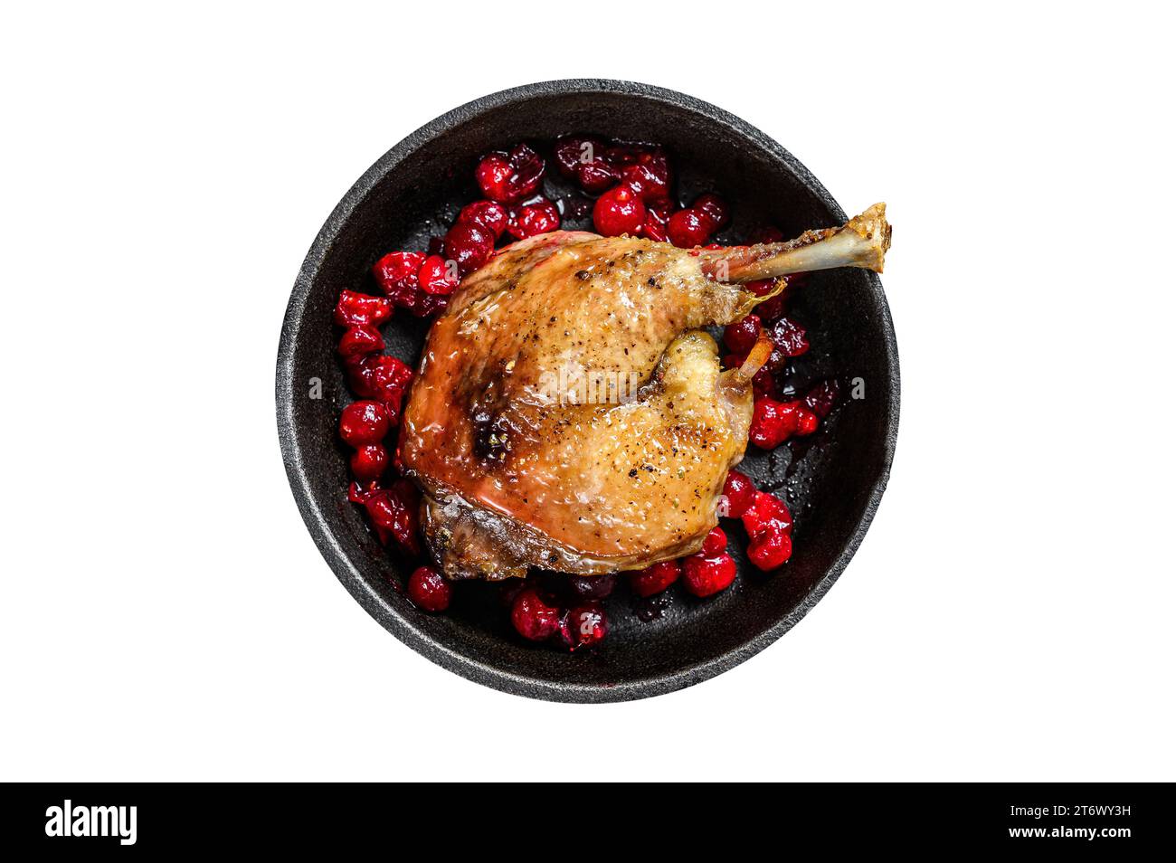 Fried duck leg with cranberrie sauce in a pan. Isolated, white