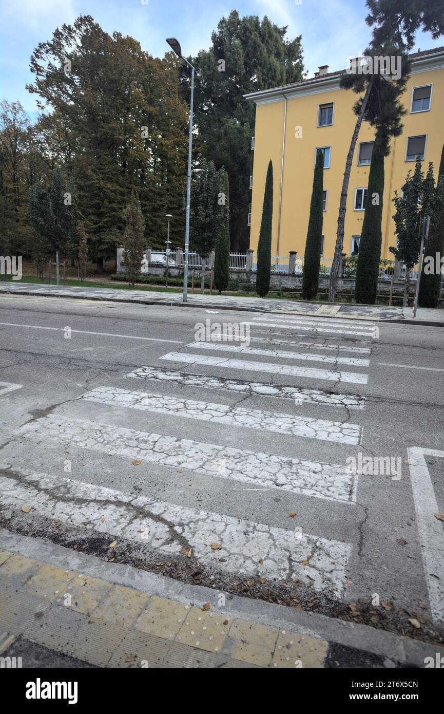 Crossing  in a street next to a park and a residential building Stock Photo