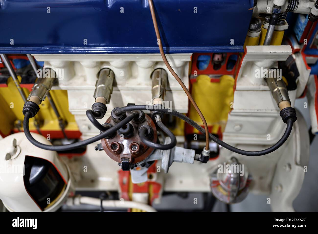 A close-up view of the carburetor and spark plugs of a mid-20th century ...