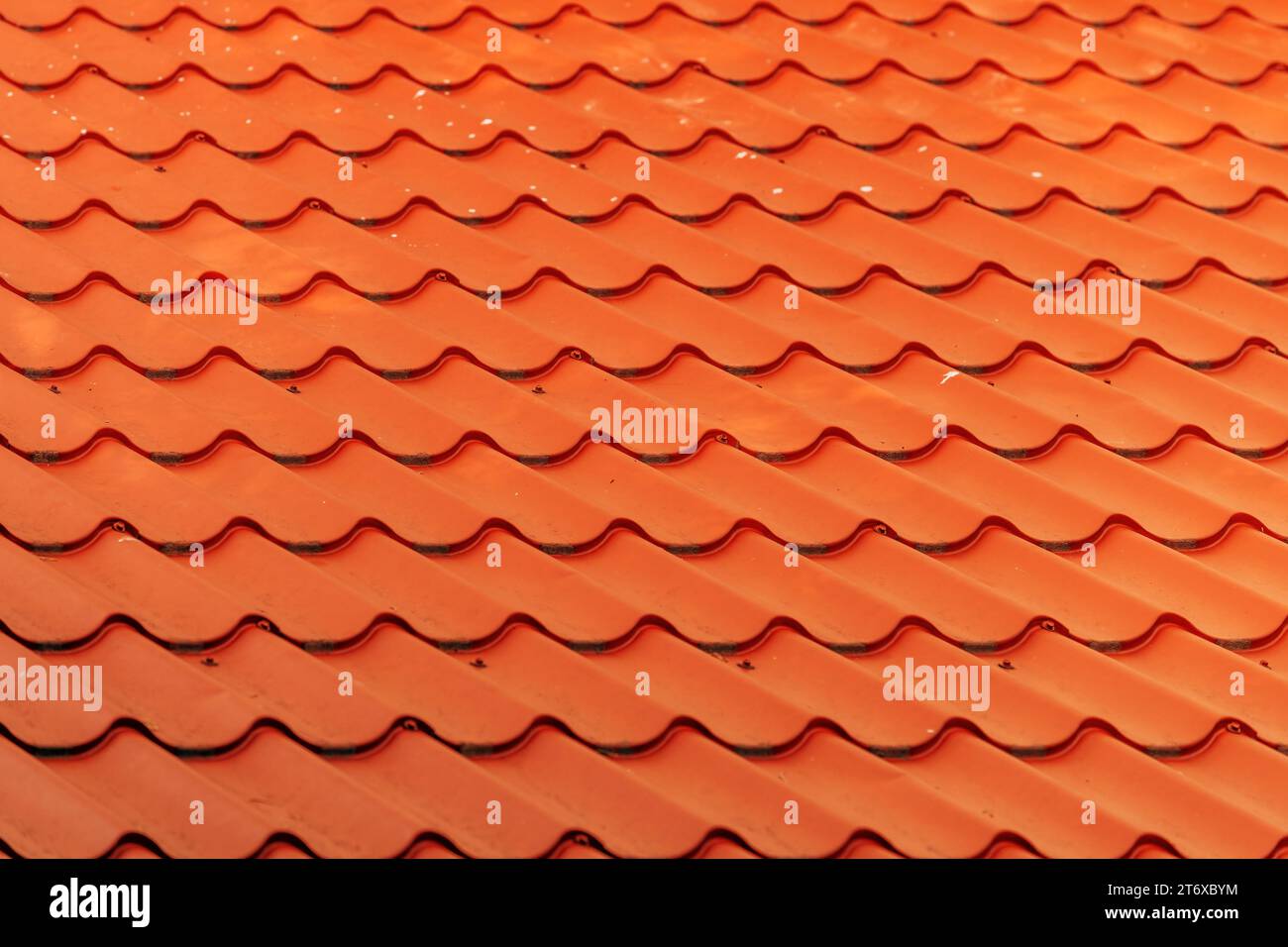 Orange metallic roof tile pattern as background, selective focus Stock Photo