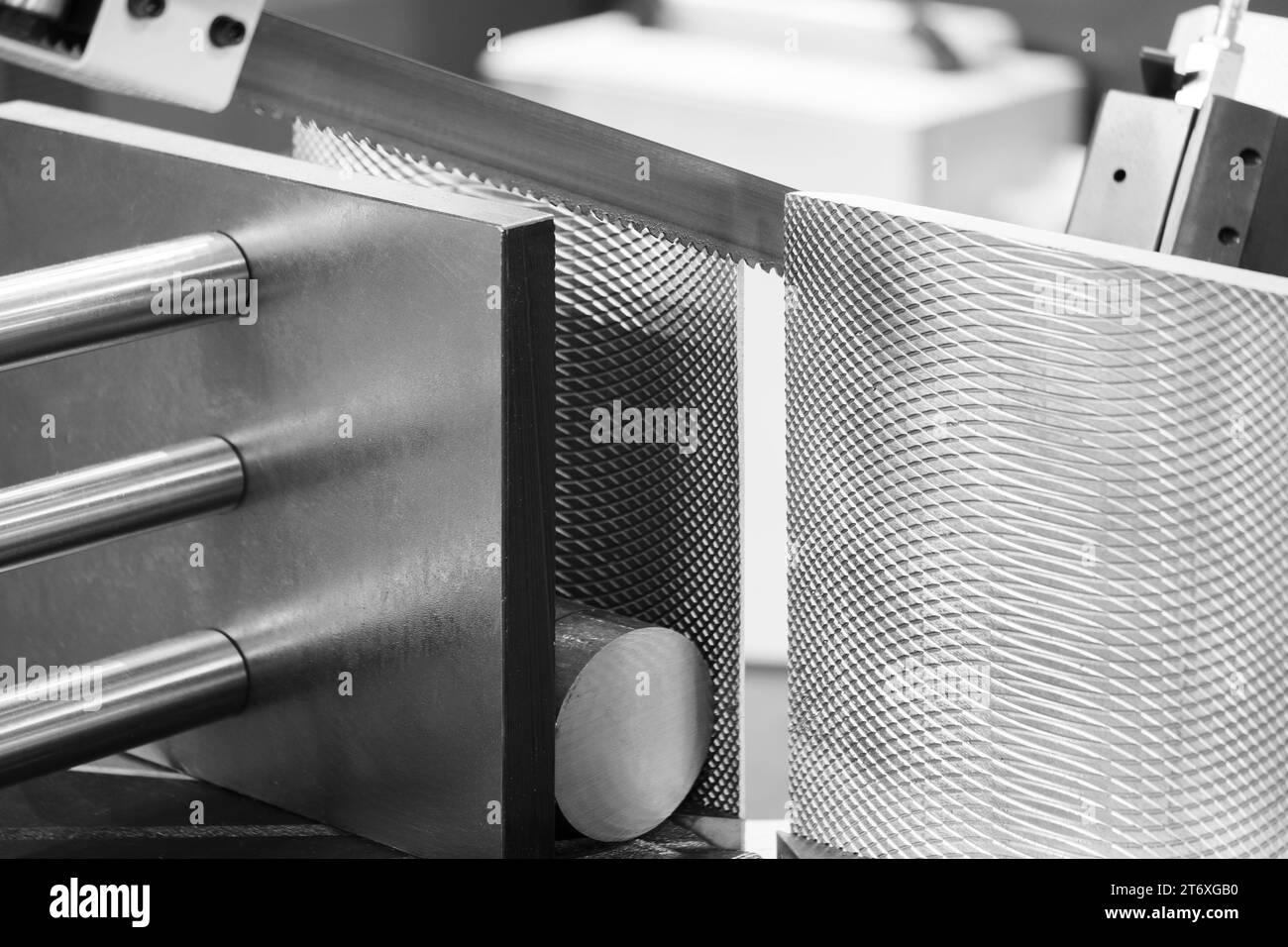 The automatic band saw machine cutting the metal bar with coolant