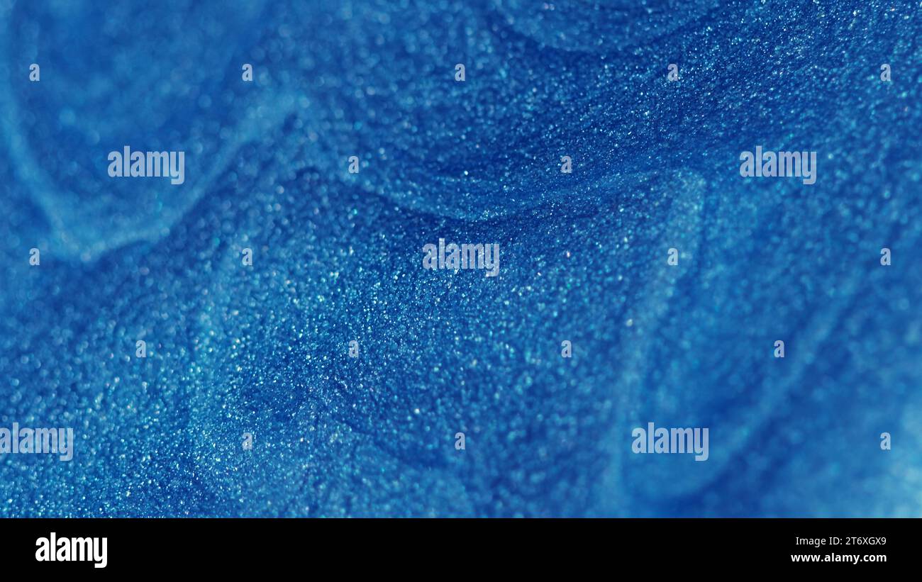 Glitter fluid paint flow blue wet texture ink wave Stock Photo Alamy