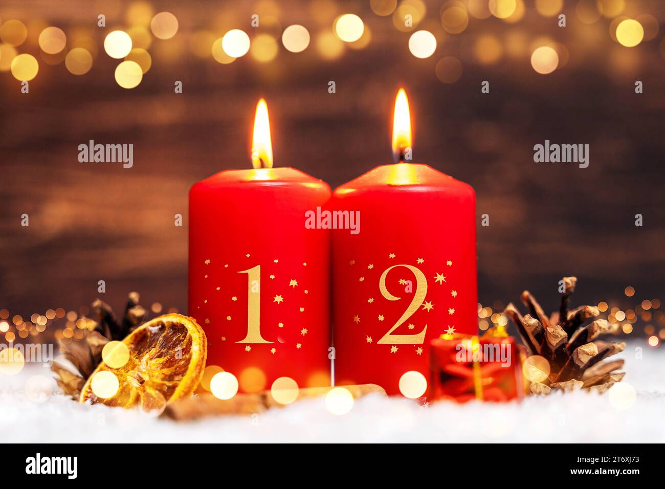 Bavaria, Germany - November 10, 2023: Two festively decorated candles burning for the 2nd Advent surrounded by winter decorations PHOTOMONTAGE *** Zwei festlich dekorierte Kerzen brennen zum 2. Advent umgeben von winterlicher Dekoration FOTOMONTAGE Stock Photo