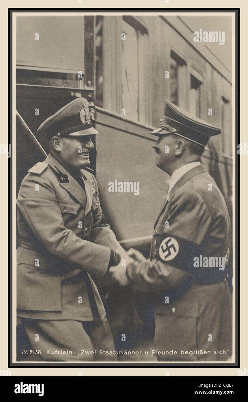 HITLER & MUSSOLINI /Nazi pre war propaganda card photo. Mussolini and Hitler 29.9.1938 KUFSTEIN  'Two Statesmen and friends greet each other'  Benito Mussolini Facist leader of Italy steps from his train and greets Adolf Hitler leader of the Nazi Party and Fuhrer of Germany. Both men wearing military uniforms. Kufstein Austria (recently annexed by Nazi Germany) Stock Photo