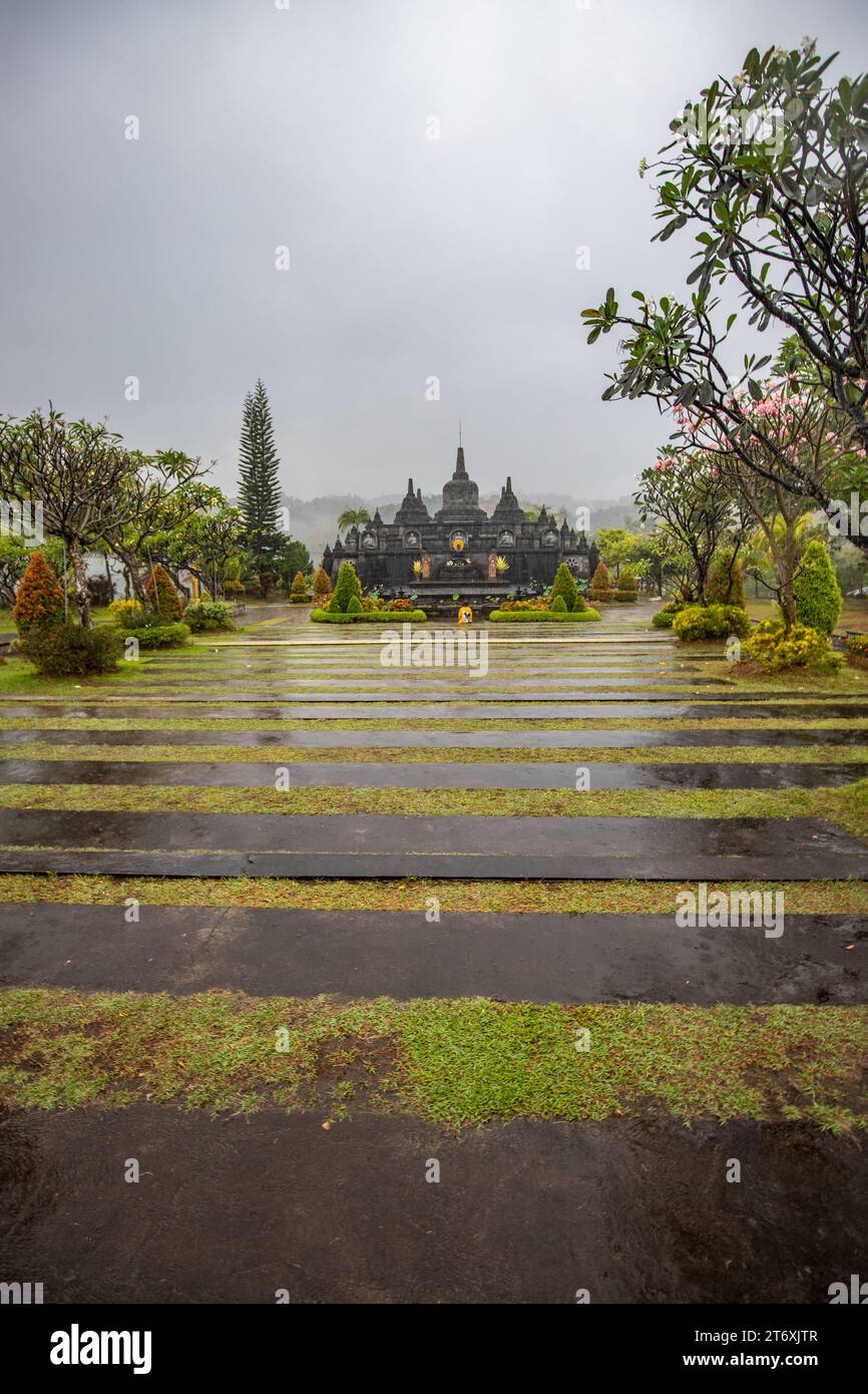 A Buddhist temple in the evening in the rain. The Brahmavihara-Arama temple has beautiful gardens and also houses a monastery. Stock Photo