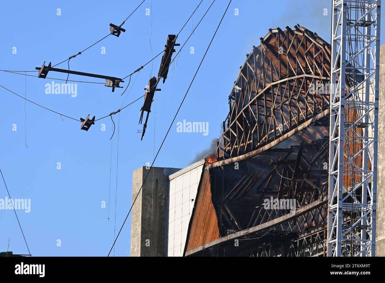 TUSTIN, CALIFORNIA - 11 NOV 2023: A hot spot Flare-up above the east doors at the MCAS Tustin Blimp Hangar, three days after the fire started. Stock Photo