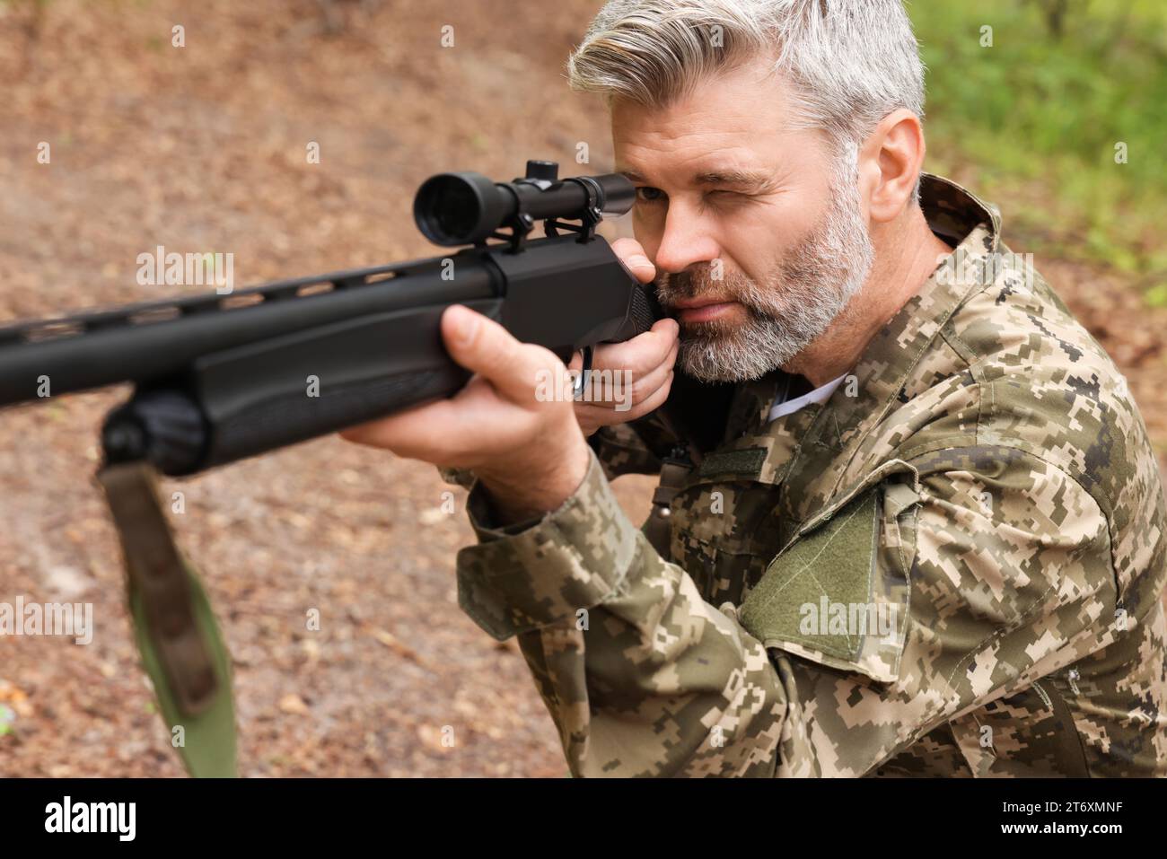 Man With Rifle Man wearing camouflage and aiming with hunting rifle outdoors Stock ...