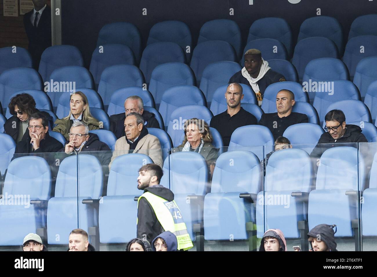 In the official stands, SSC Napoli's Nigerian forward Victor Osimhen and brothers Paolo and Fabio Cannavaro watch the match together with Napoli president Aurelio De laurentiis during the Serie A football match between SSC Napoli and Empoli at the Diego Armando Maradona Stadium in Naples, southern Italy, on November 12, 2023. Stock Photo