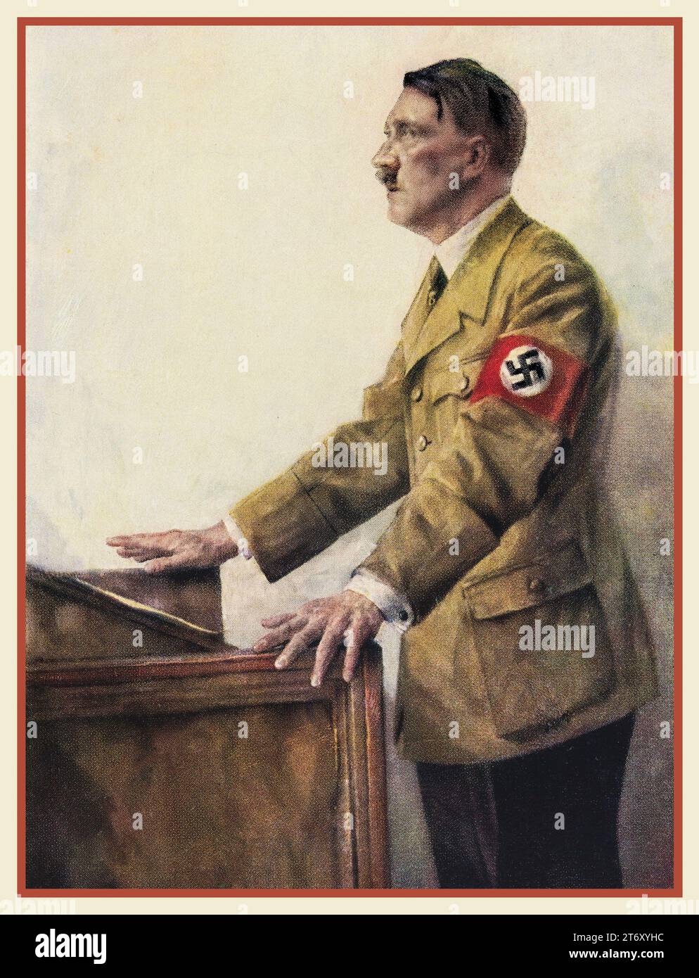 1930s Adolf Hitler 'The Fuhrer' in military uniform wearing a swastika armband, standing at a podium making a speech. Colour  illustration by H J Mann. Hitler was The Fuhrer and leader of the Nazi Party. Nazi Germany. Hoffman colour lithograph. 1938 Stock Photo
