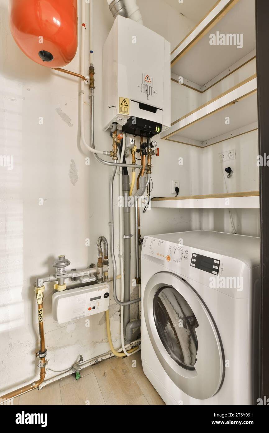a white washer and dryer in a laundry room with wood flooring on the