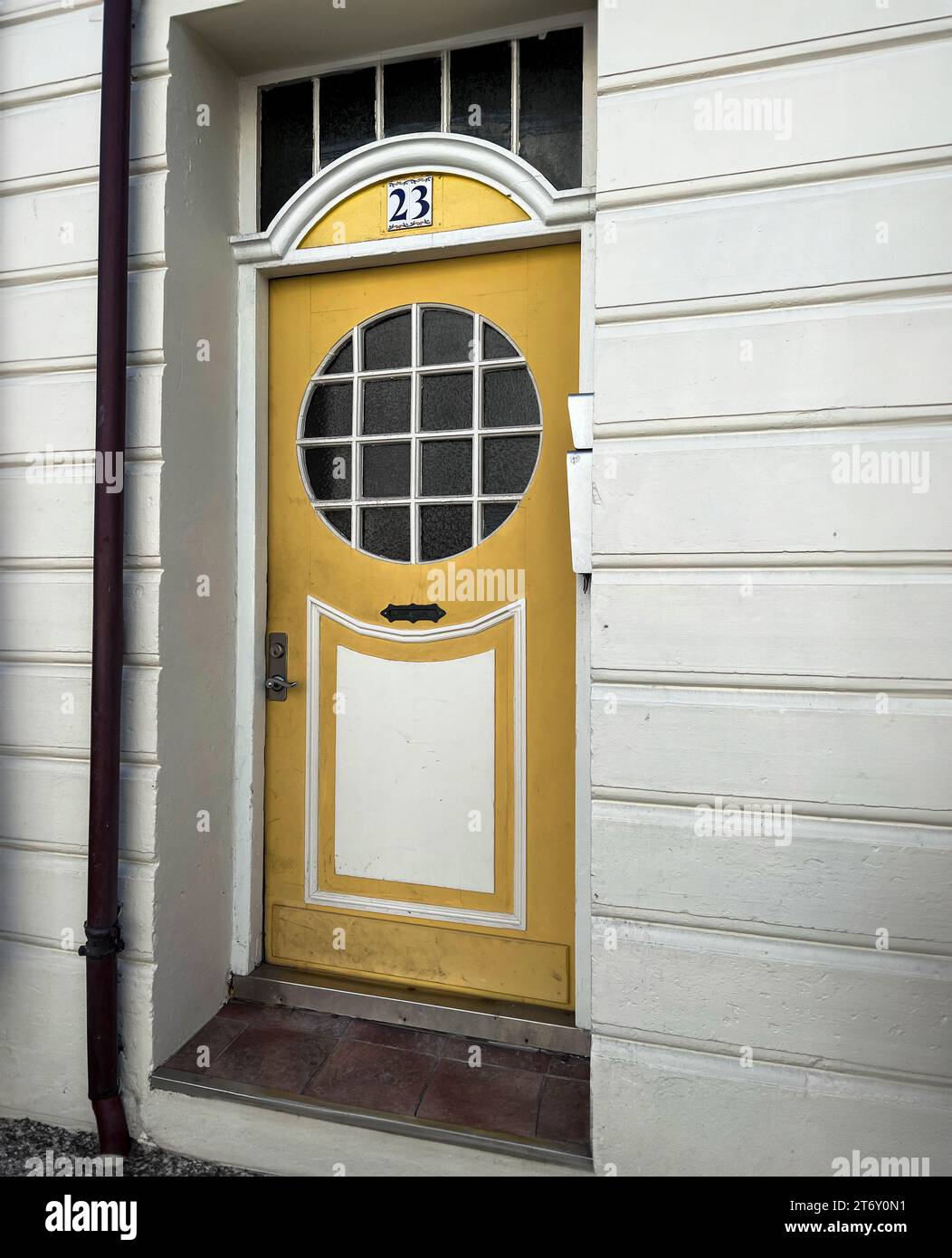 yellow vintage door in a historic house Stock Photo