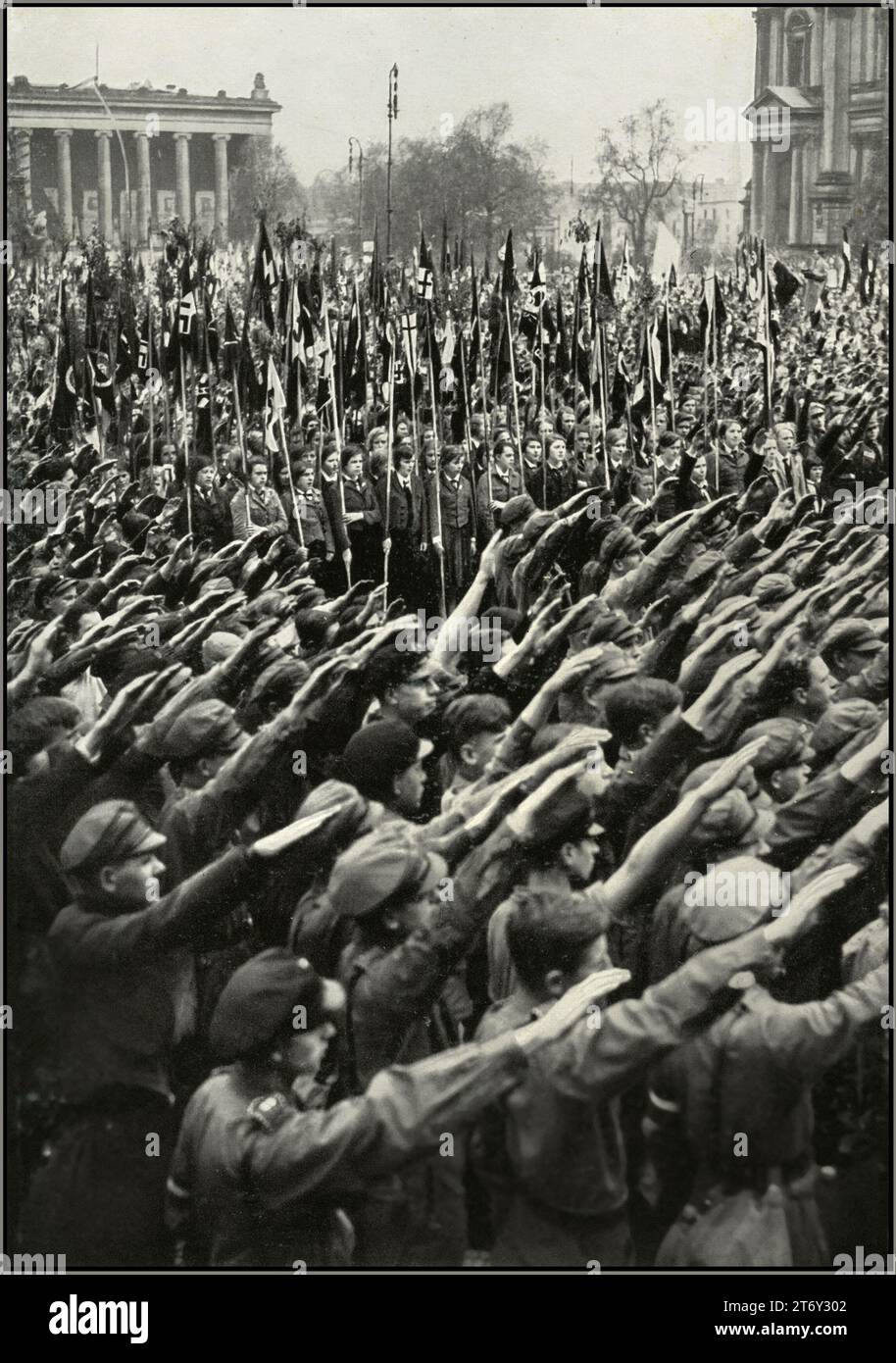 1930s Nazi Germany youth rally in the Pleasure Garden Berlin, with swastika flag carrying BDM League of German Girls and HitlerJugend Hitler Youth giving the Nazi Party Heil Hitler salute to Fuhrer Adolf Hitler. 'Germany Awakes' The rise of Nazism in Germany 1930s Stock Photo