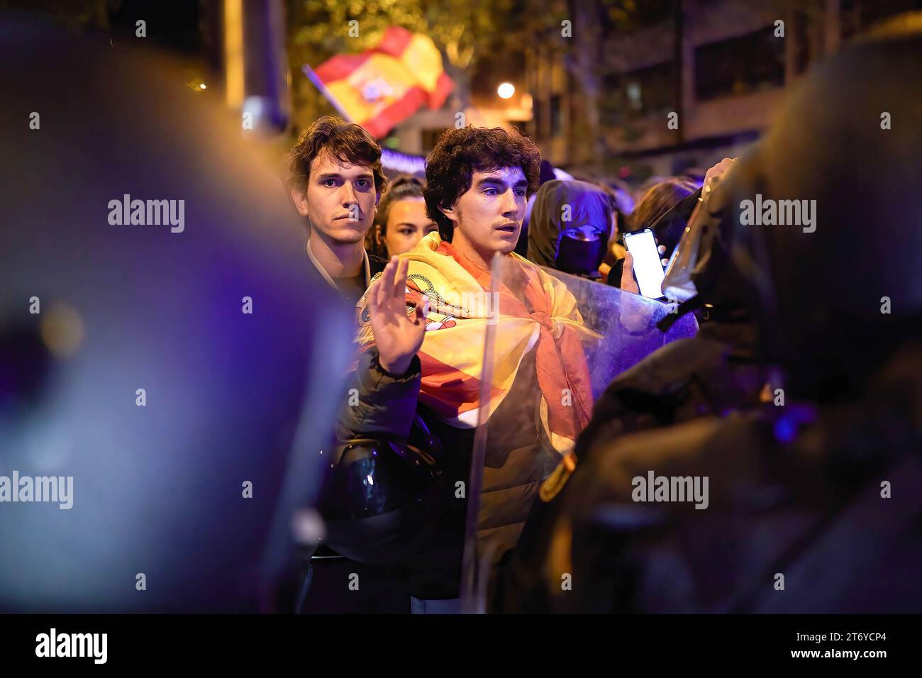 A demonstrator raises his hands as a symbol of non-resistance while blocking MarquÈs de Urquijo street during the protest. Protests against an amnesty for Catalan independence, supporters repeated on Saturday for the ninth consecutive day in different parts of Spain, including Madrid, where the action of groups of radicals ended with a provisional balance of 13 people arrested and five injured. (Photo by Edgar GutiÈrrez / SOPA Images/Sipa USA) Stock Photo