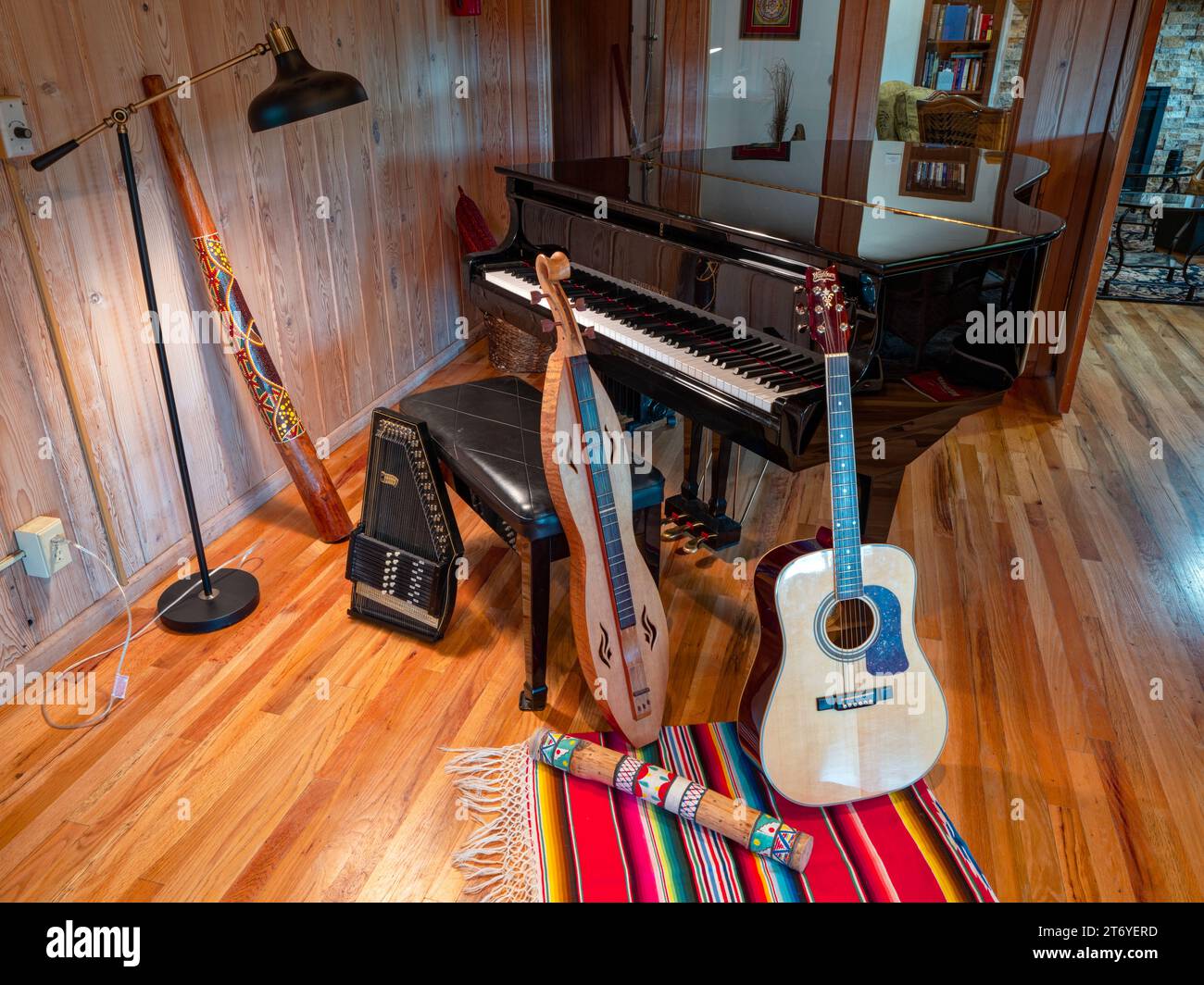 A collection of musical instruments around a piano Stock Photo - Alamy