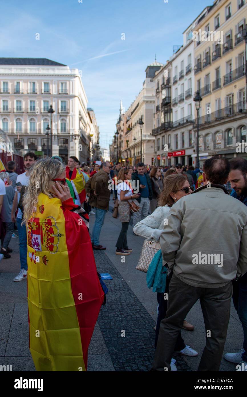 Different images of a demonstration held in Madrid at La Puerta del Sol where different people can be seen walking through the city carrying Spanish f Stock Photo