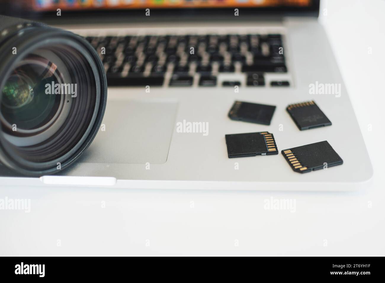 Close up camera lens memory cards laptop Stock Photo