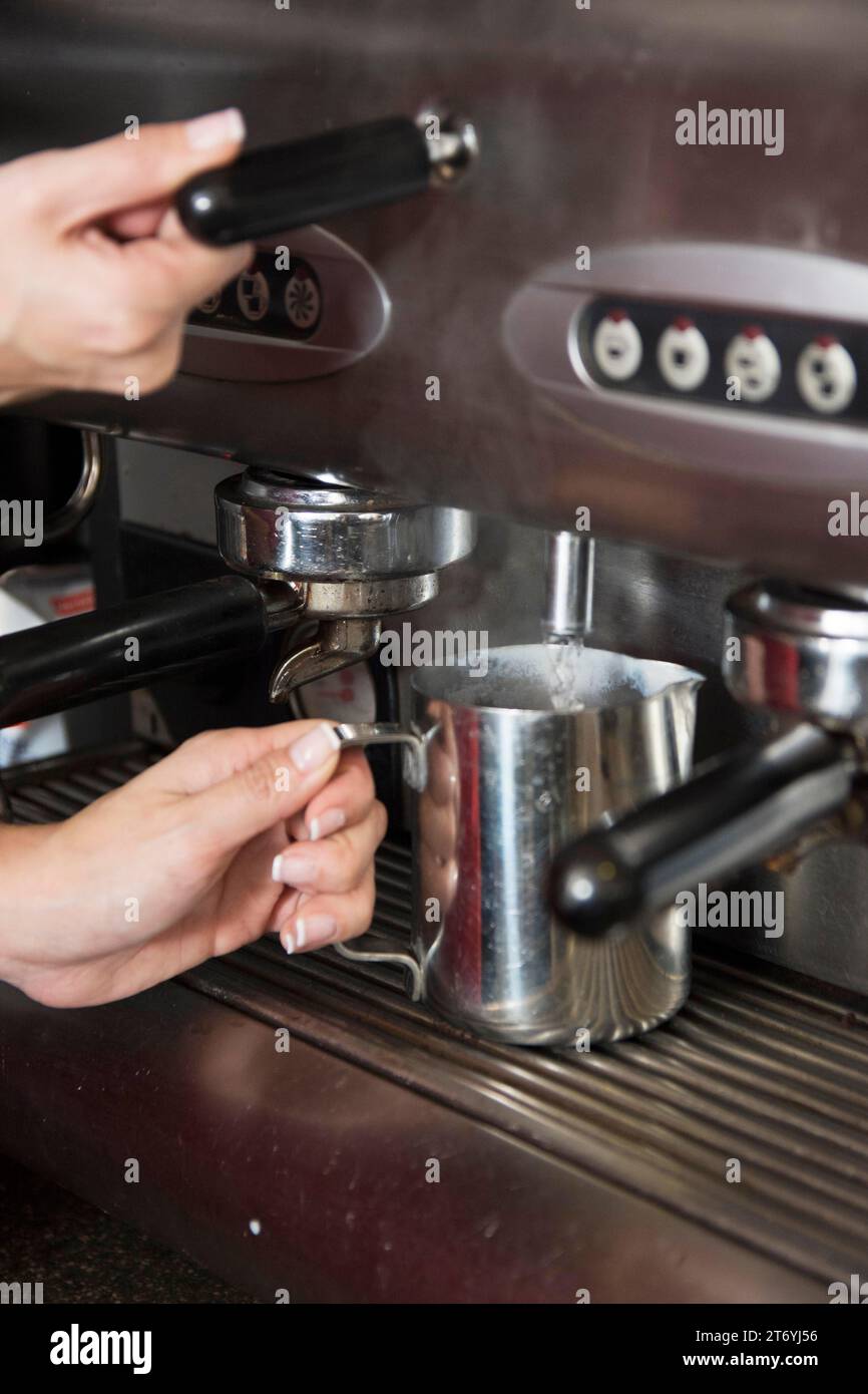 Barista taking hot water from tap mug Stock Photo Alamy