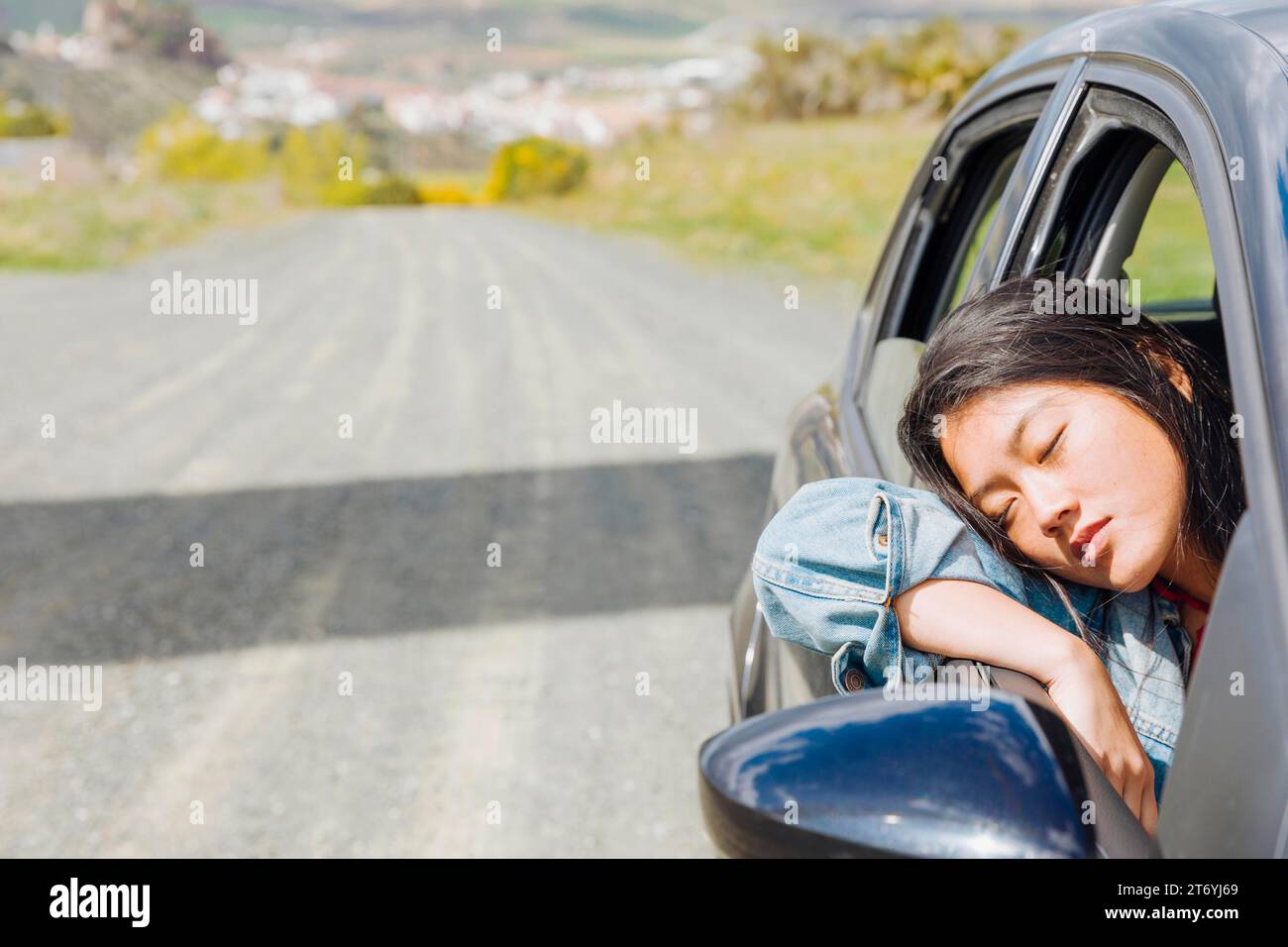 Asian woman napping car during roadtrip Stock Photo