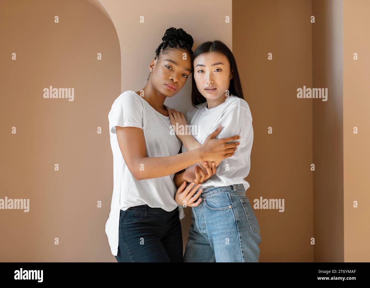Medium shot women holding each other Stock Photo - Alamy
