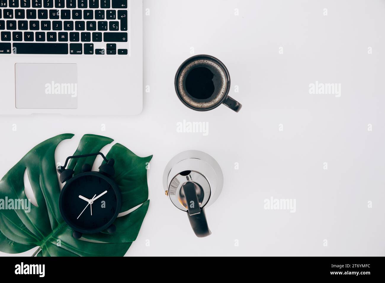 Monster leaf alarm clock kettle coffee cup laptop white background