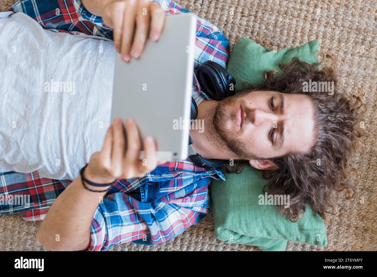 Modern man using tablet home Stock Photo