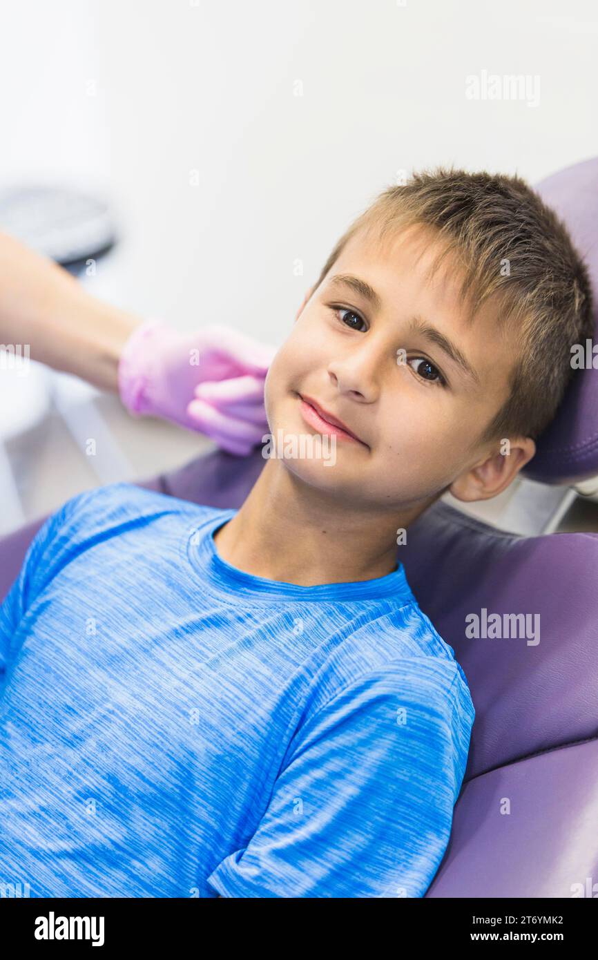 Portrait boy leaning dental chair Stock Photo