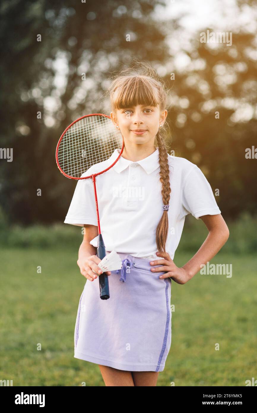 Portrait confident girl standing with badminton shuttlecock Stock Photo