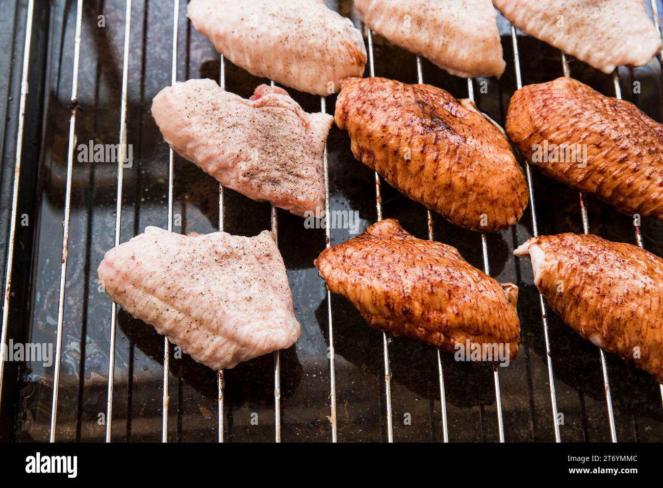 Preparation chicken wings metal grill Stock Photo Alamy