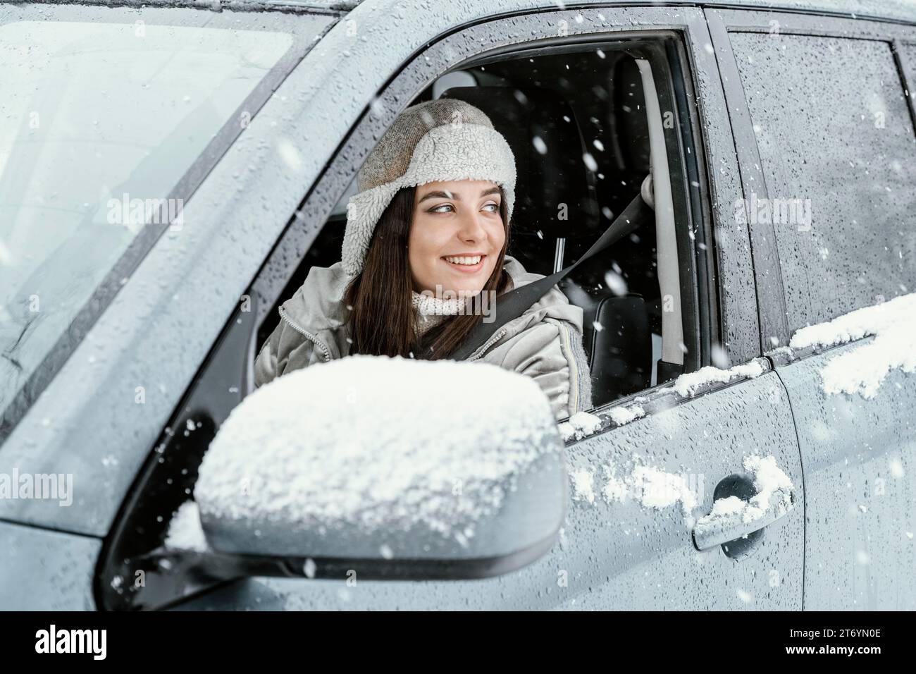 Side view smiley woman driving car road trip Stock Photo - Alamy