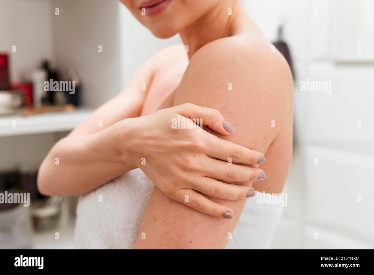 Woman holding her arm bathroom Stock Photo