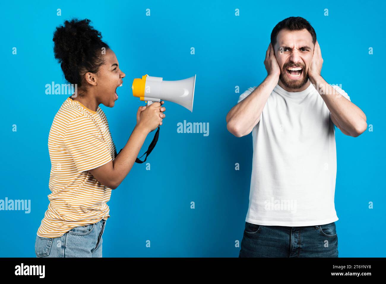Woman yelling man through megaphone Stock Photo Alamy