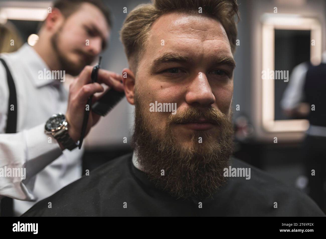 Attractive man having hair cut Stock Photo