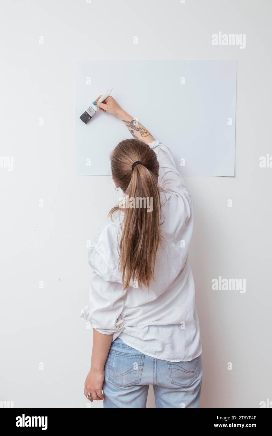 Artist drawing picture paper wall Stock Photo