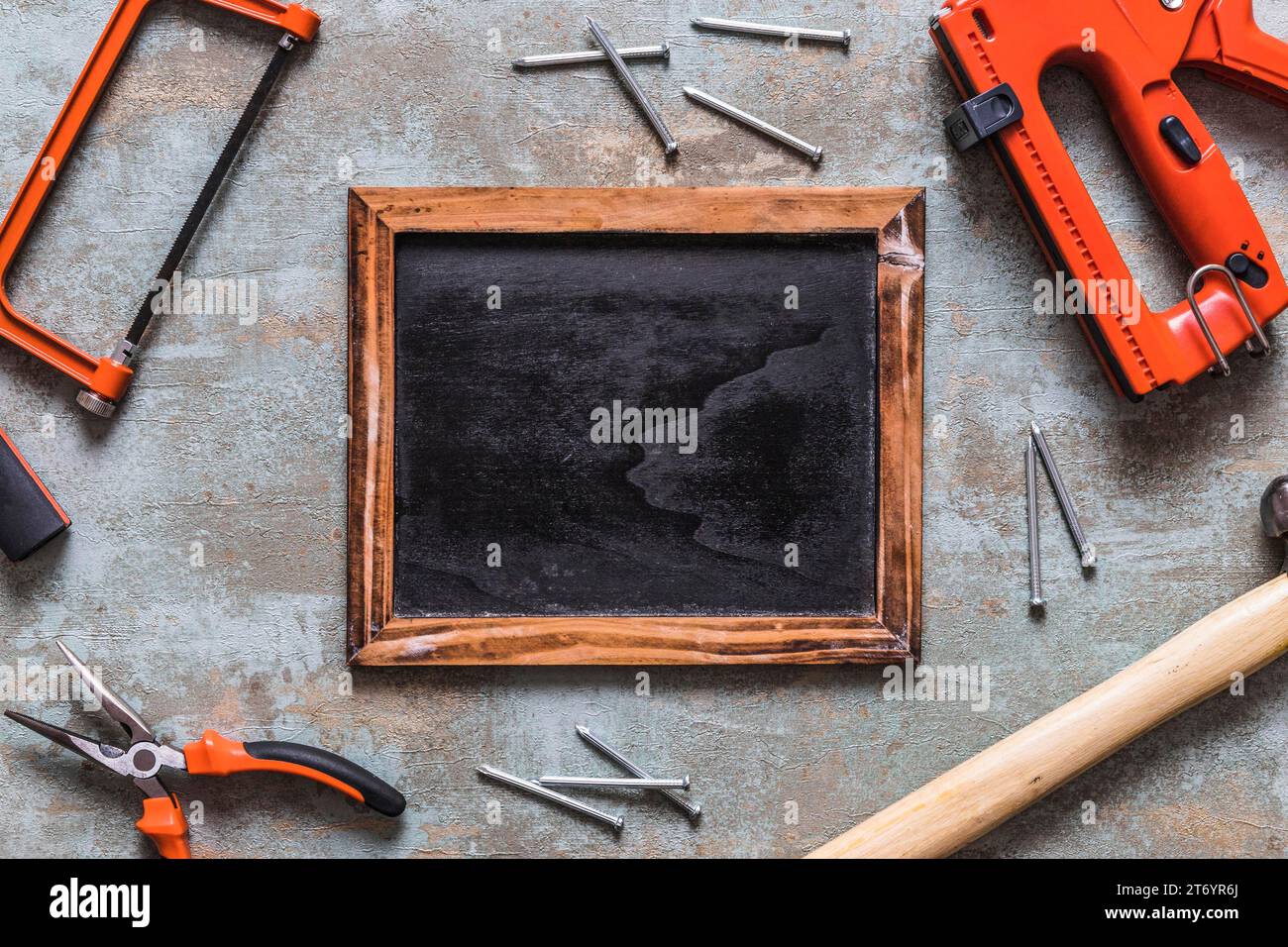 Elevated view blank slate surrounded by various worktools Stock Photo