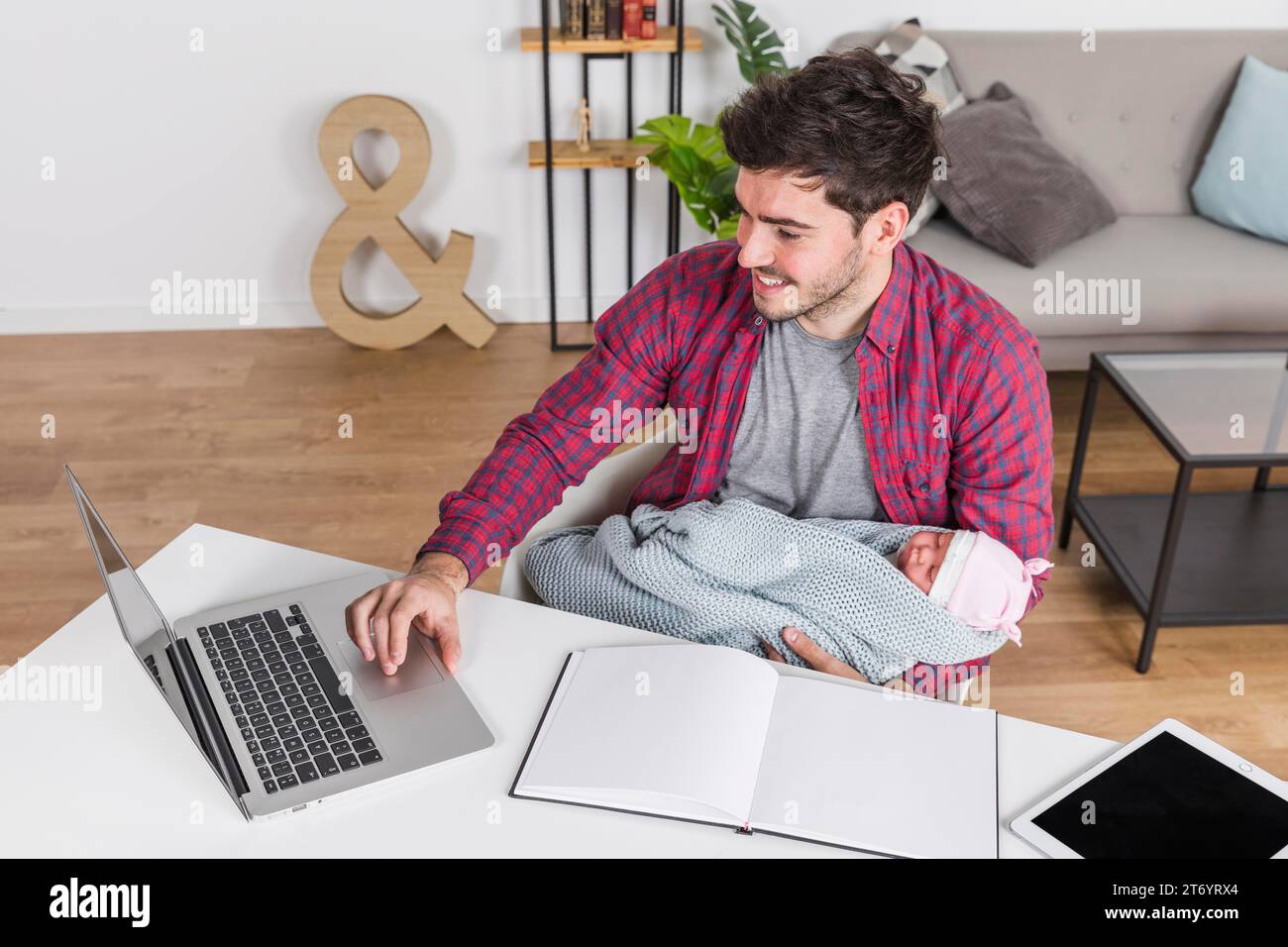 Happy father with baby using laptop desk Stock Photo - Alamy