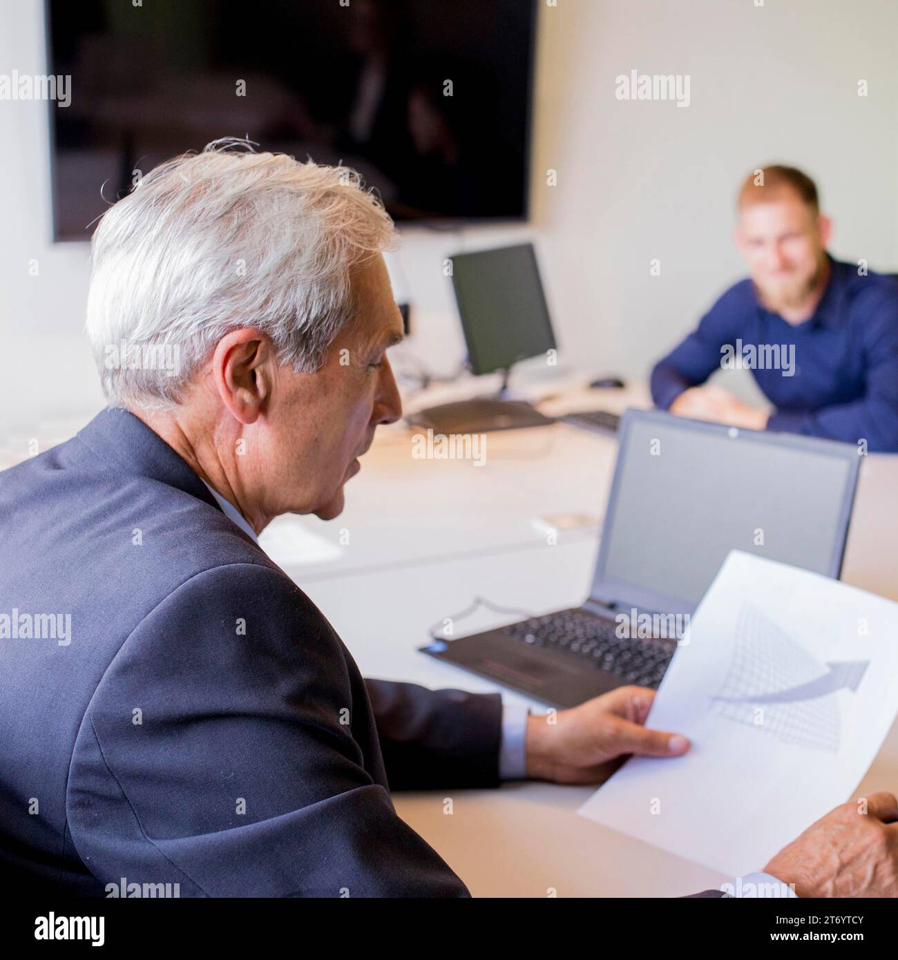 Mature businessman analyzing graph office Stock Photo