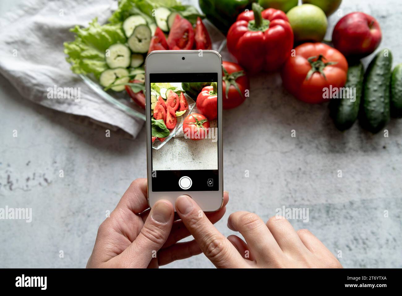 Person hand taking picture fresh vegetable background Stock Photo