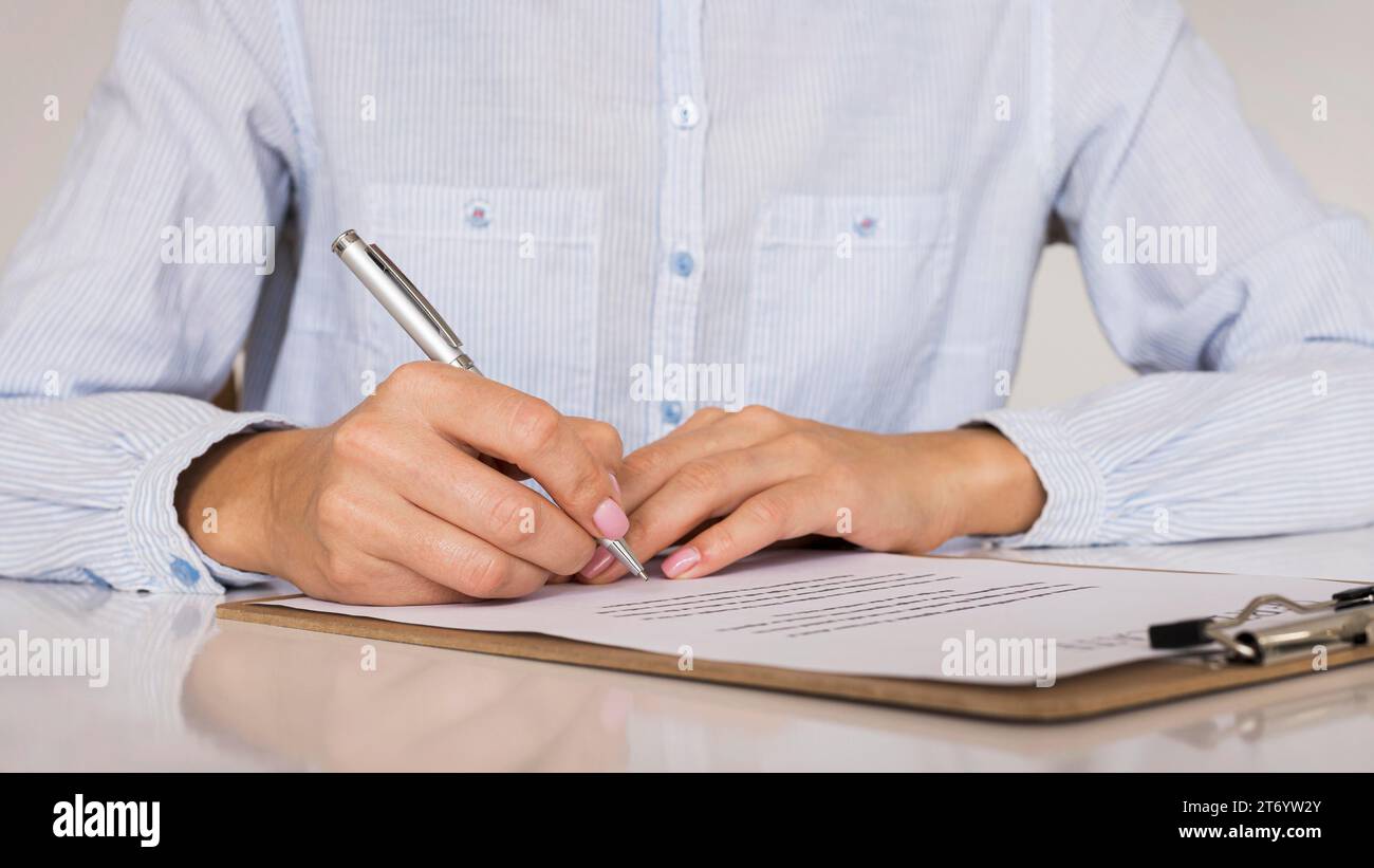 Person signing contract certificate Stock Photo Alamy