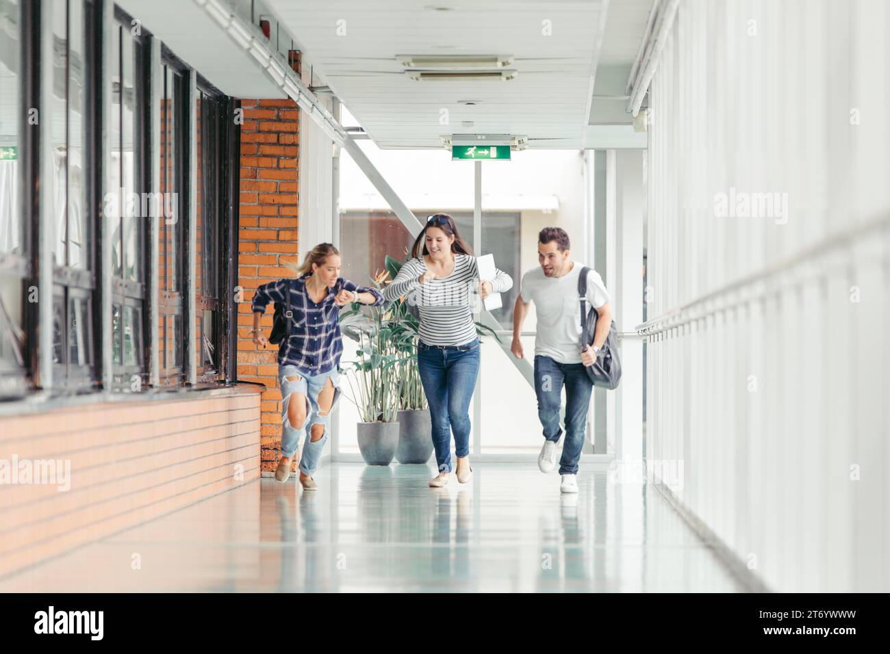 Three students running hi-res stock photography and images - Alamy